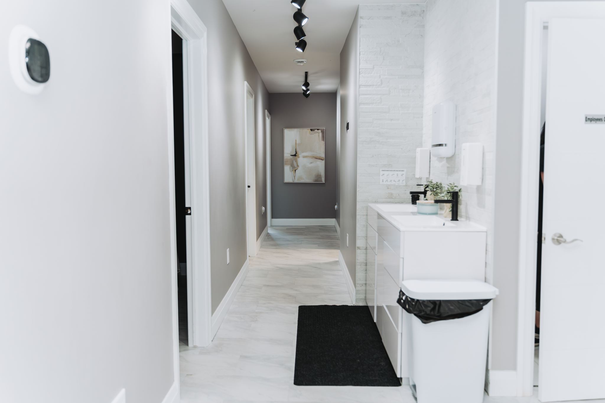 Clean, modern hallway and treatment rooms at MYO